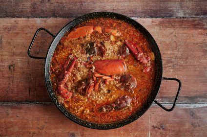 Rice with lobster on wooden background, top view